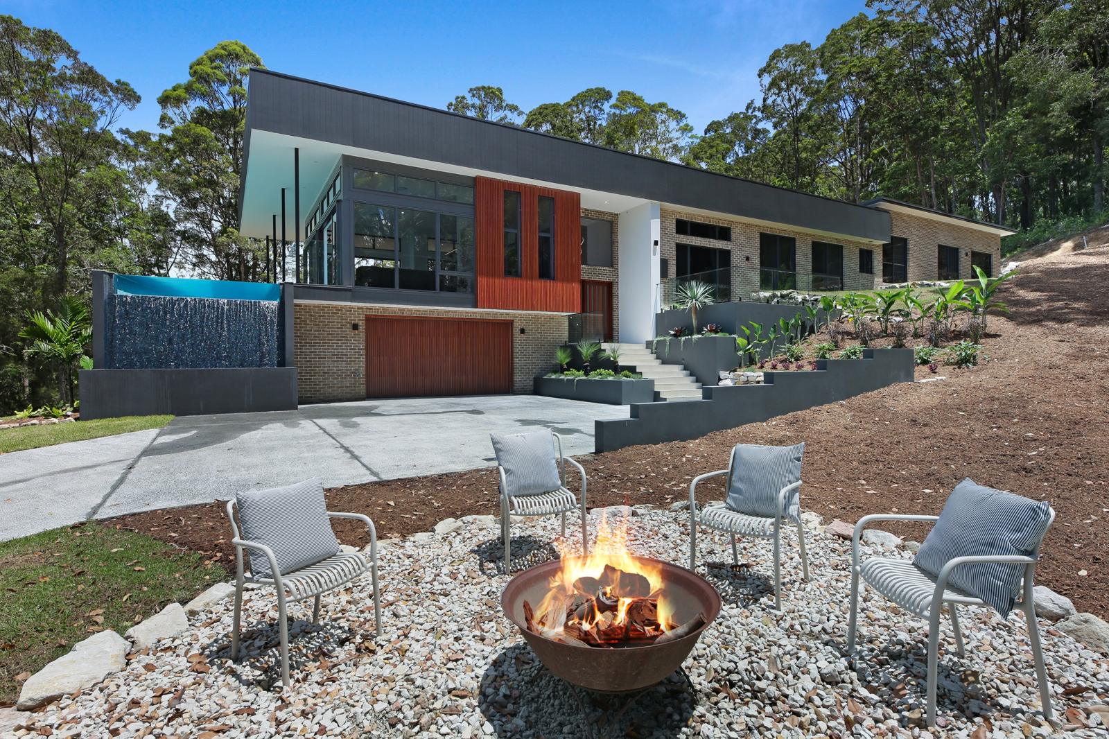 Tally 2.0 exterior with waterfall pool wall and fire pit
