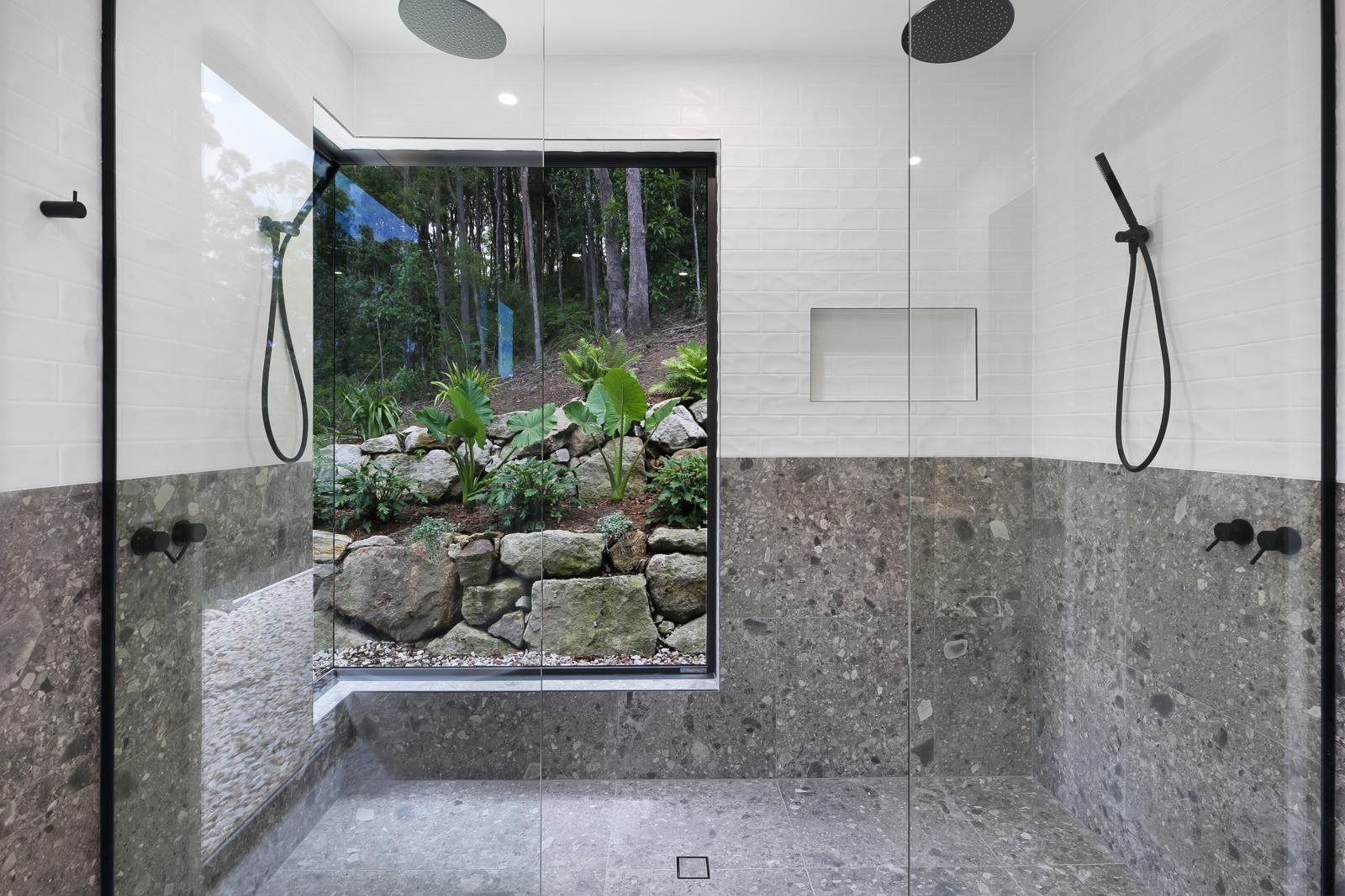 Twin rain shower with a rock garden view