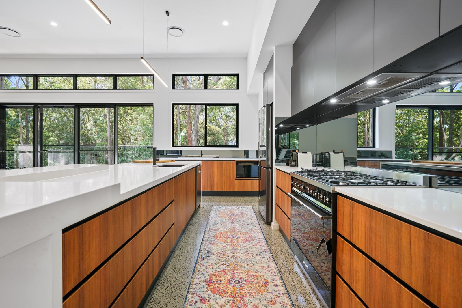 Kitchen with timber cabinetry and stone benches