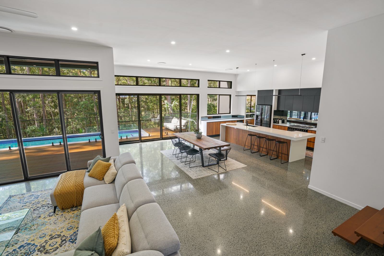 Open-plan living, dining and kitchen opening to the pool