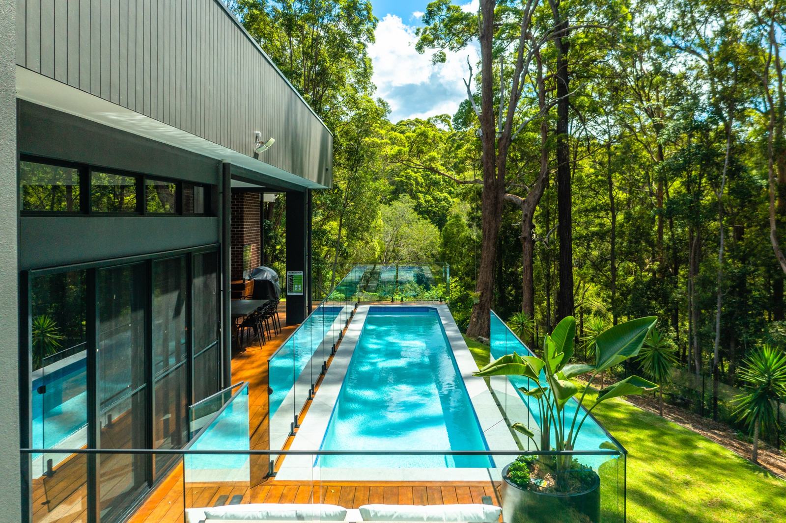 Tally 1.0 lap pool and deck looking into the forest